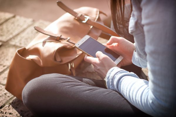 student browsing smartphone