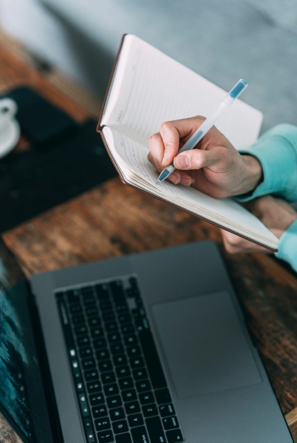 hand writing in note book setting goals targets landlords letting agents