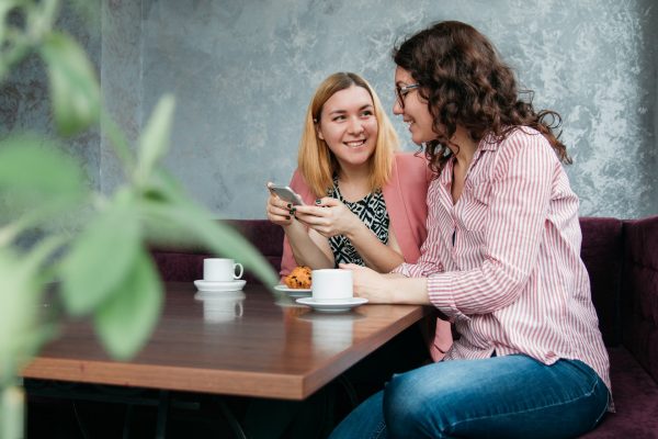 two-woman-talking-at-table