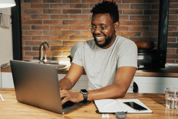 man-on-computer-smiling